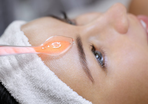 The cosmetologist makes the procedure electrotherapy  of the facial skin of a beautiful, young woman in a beauty salon.Cosmetology and professional skin care.