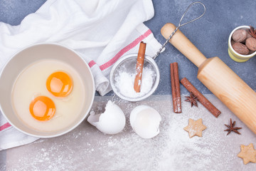 Naklejka na ściany i meble Christmas gingerbread cookies with whisk, eggs, dough and rolling pin.