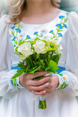 wedding bouquet in the hands of the bride in the national Ukrainian dress