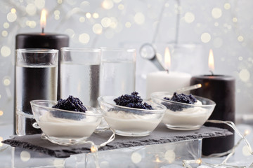 Festive buffet with vodka, black cavier and candles. Celebration concept for Christmas, new year or other party