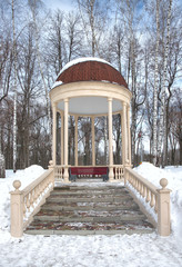 Winter landscape. Beautiful gazebo with columns in a winter park.