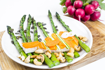 Funny healthy sandwich with cheese, carrots, asparagus and cashew nuts in the form of fish meal ideas for kids