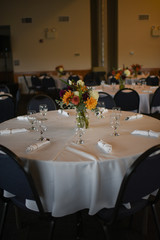 Wedding Photography: Fall Wedding Centerpieces on a White Table Indoors
