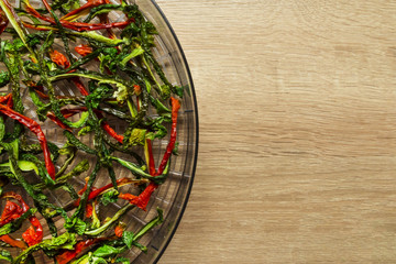 dry red and green bell pepper on wood background. space for text