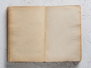 Open vintage book blank on white concrete background. Top view or flat lay. Copy space.