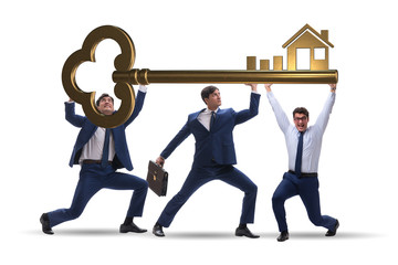 Businessmen holding giant key in real estate concept