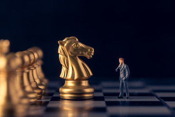 Chess and man model on a chessboard at black background, Business leader concept. vintage tone.