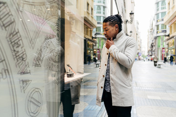 Black man exploring display of store