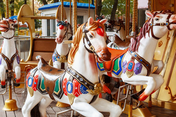 Fototapeta na wymiar carousel horse in amusement park. A close-up of a horse carousel at the attractions.