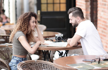 Beautiful loving couple sitting in a cafe enjoying in coffee