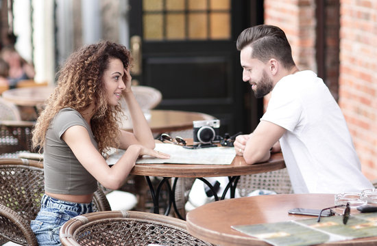 Beautiful loving couple sitting in a cafe enjoying in coffee