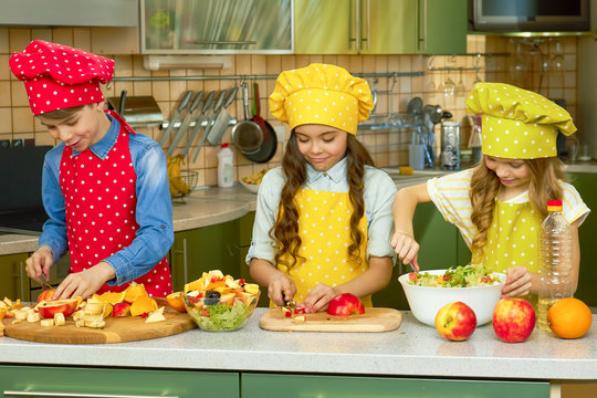 Children Making Salad. Fresh Fruits And Lettuce. Cooking School For Kids.