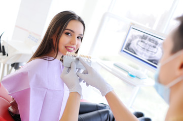 The dentist talks with the patient about dental care and selects the patient the color of the tooth...