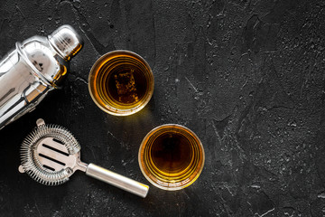Alcohol cocktails with whiskey and ice, bartender tools black bar background top view mockup