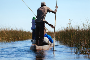 Man in canoe , Okavango river  - 176768305