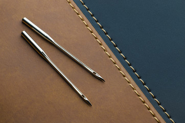 sewing machine needles for leather on dark brown leather stitched with black leather using yellow...