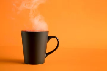 Fotobehang Coffee cup with steam on orange © eshma