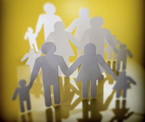 Family silhouettes with children isolated on yellow background, conceptual image