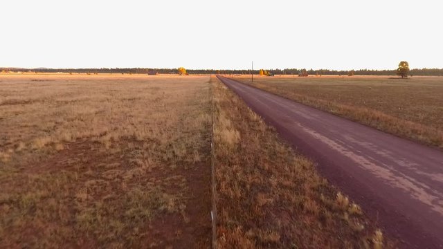 Aerial view of a ranch fence along a dirt road