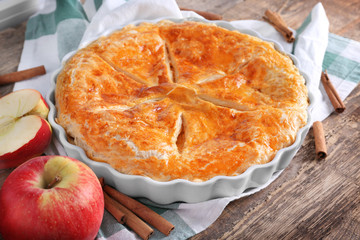Delicious pie with apples on table