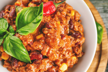 Plate with chili con carne on table, closeup
