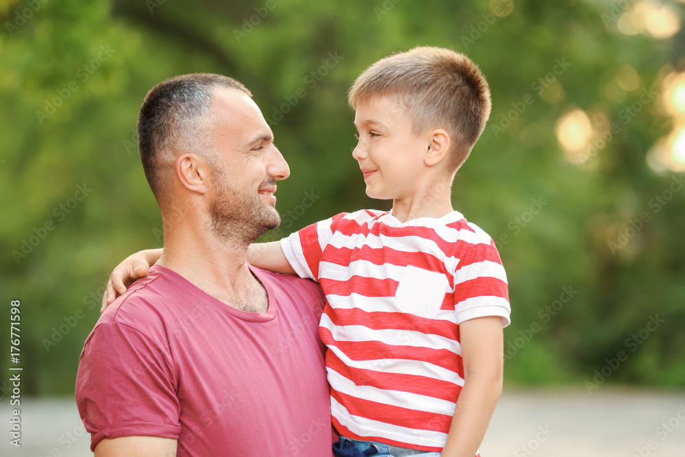 Wall mural cute boy with father in park