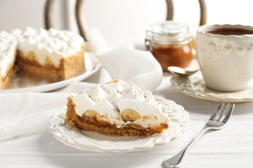 Plate with delicious banana cake on table
