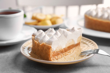 Plate with delicious banana cake on table