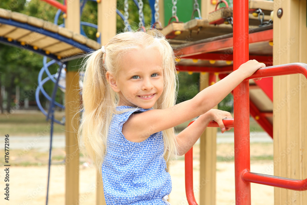 Poster Cute little girl on playground