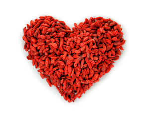 Red dried goji berries on white background. Heart health concept