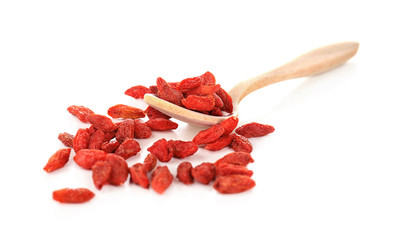 Wooden spoon with red dried goji berries on white background
