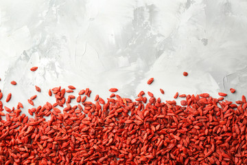 Red dried goji berries on grey background