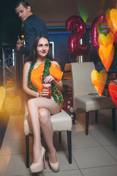 Romantic mood at Christmas party. Pretty young girl sitting alone, interested handsome male. Flirty dalliance, night club background, modern youth lifestyle