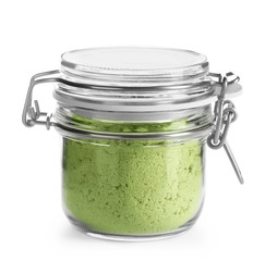 Glass jar with wheat grass powder on white background