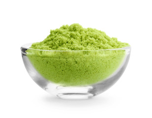 Bowl with wheat grass powder on white background