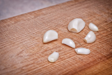 Garlic cloves closeup on wooden Board