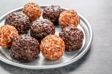 Brown and red rice balls on metal tray