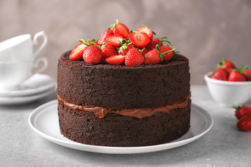Plate with delicious chocolate cake on table