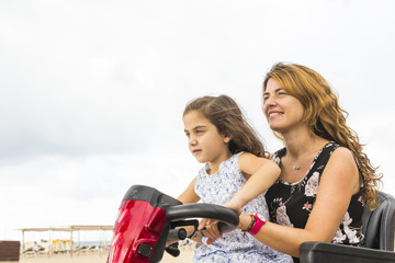 Mother and daughter with a motorized chair