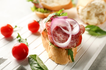 Delicious sausage sandwich on wooden board