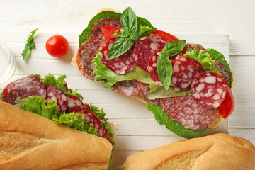 Delicious sausage sandwiches on wooden board