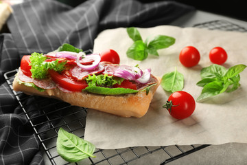 Composition with delicious sausage sandwich on rack