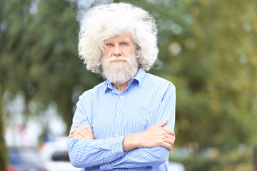 Mature man with grey hair outdoors