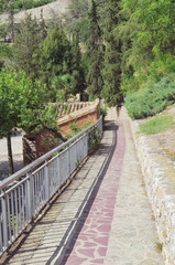 Obraz premium Sunny scene. Slope with railing. Street with stone pavement at the fortified town of Albarracin (Teruel - Spain). Touristic place. Beautiful medieval environment.