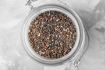 Jar with chia seeds on table, closeup