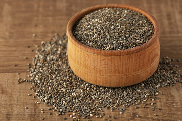 Bowl with chia seeds on wooden table