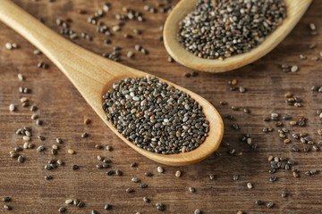 Spoons with chia seeds on table, closeup