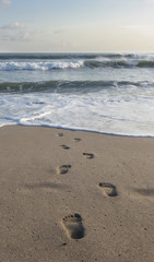 Footprints at sand, coastline,ocean.