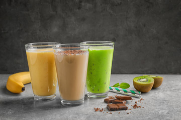 Glasses with different protein shakes on table