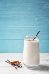 Vanilla and cinnamon protein shake in glass on table